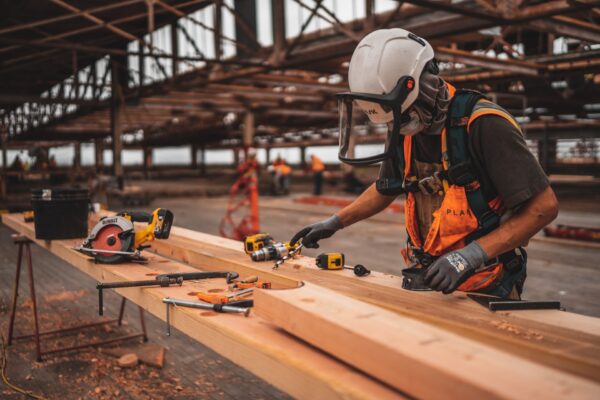 Construction worker wearing a hard hat, face shield, and safety vest,